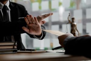 Business man raised her hand to deny accepting a bribe from a business partner.